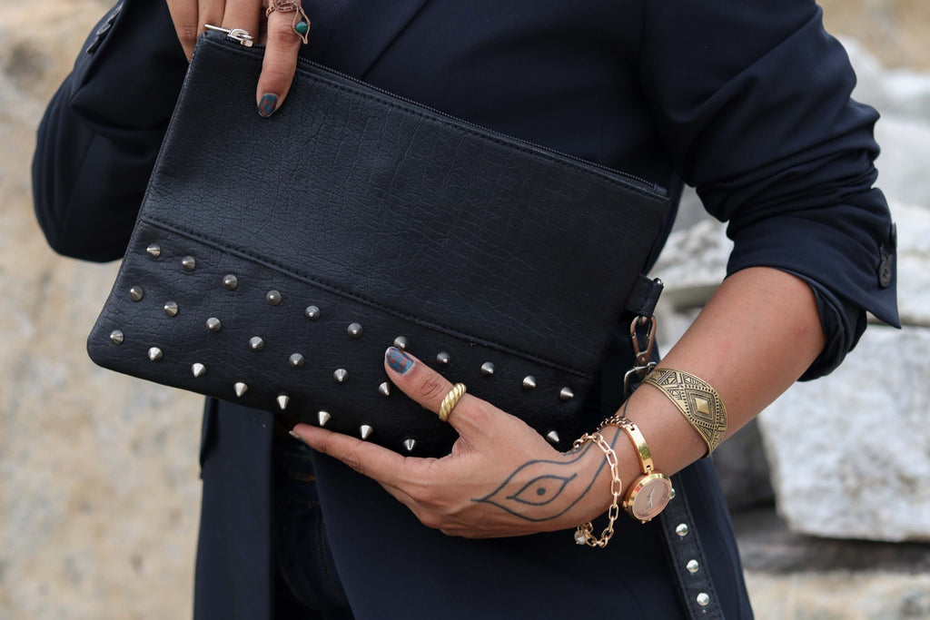 Alchemy pouch held against a dark blazer