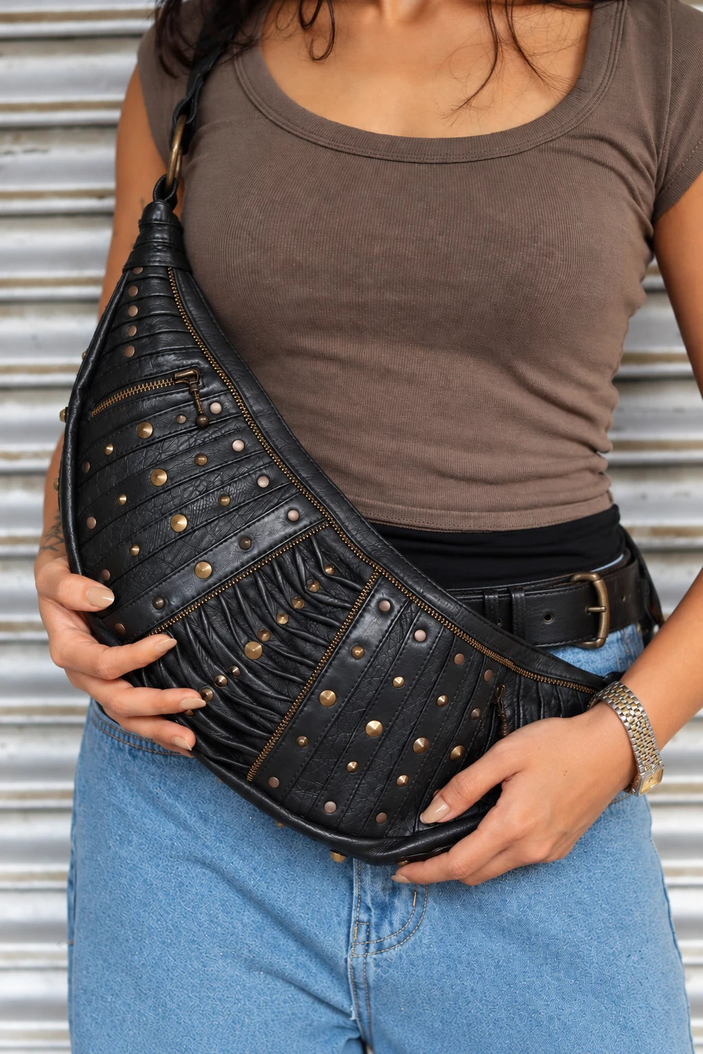 Hollow Moon sling bag held with both hands